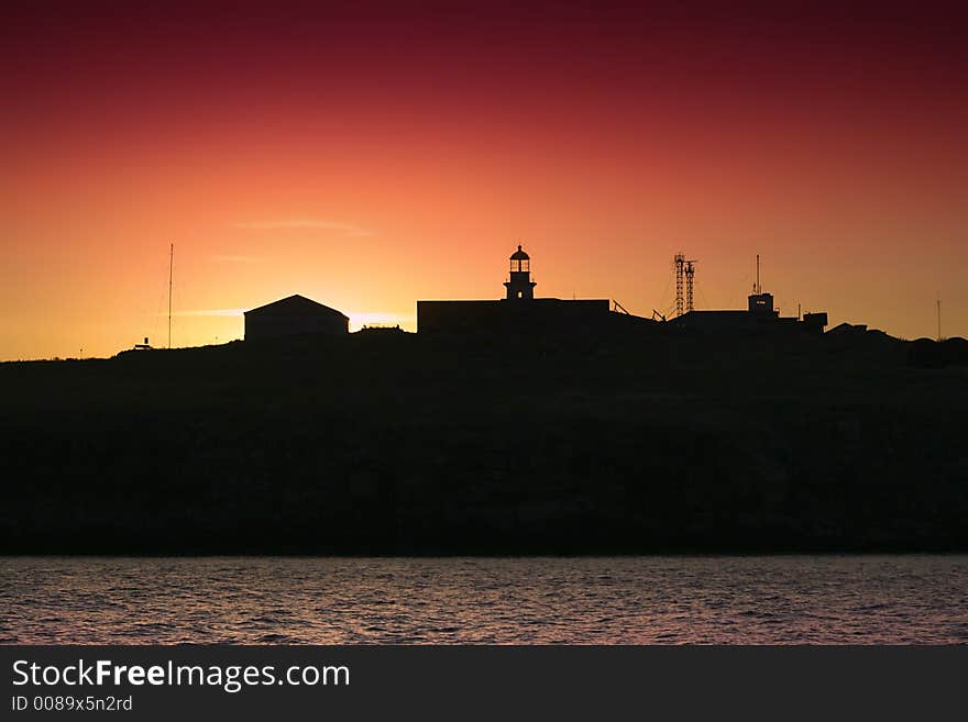 Silhouette of an island and lighthouse