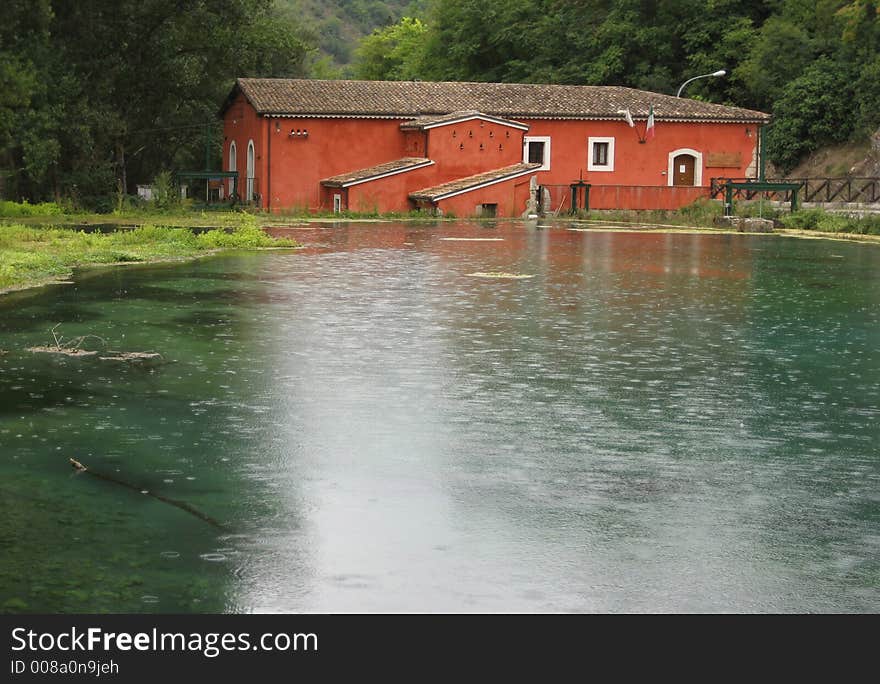 Red house in lake of Posta Fibreno (Italy), rainy day