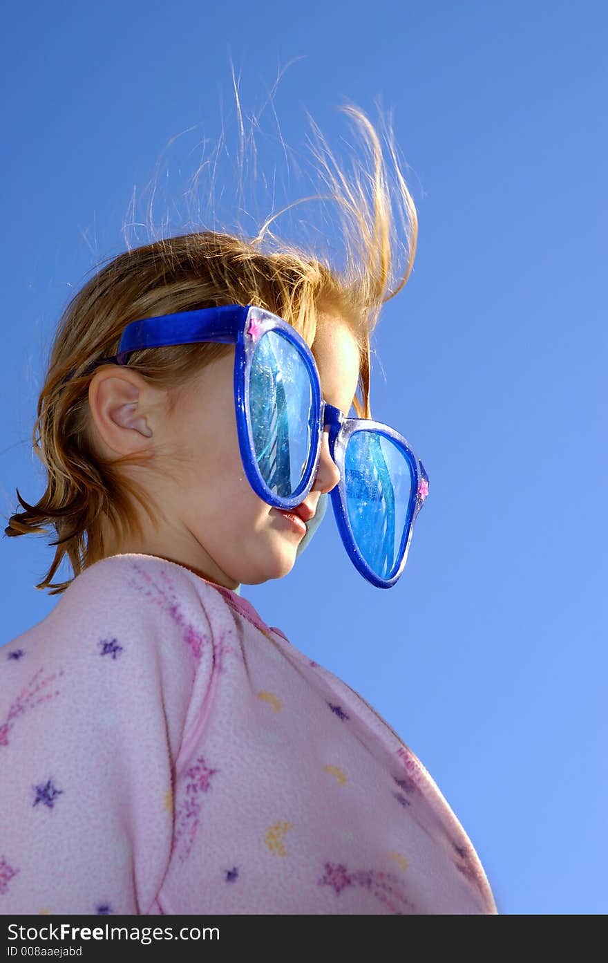 Little blonde girl wearing goofy sunglasses. Little blonde girl wearing goofy sunglasses