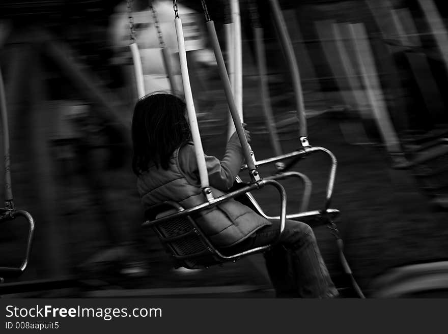 Girl in playground on a carousel, motion blur. Girl in playground on a carousel, motion blur