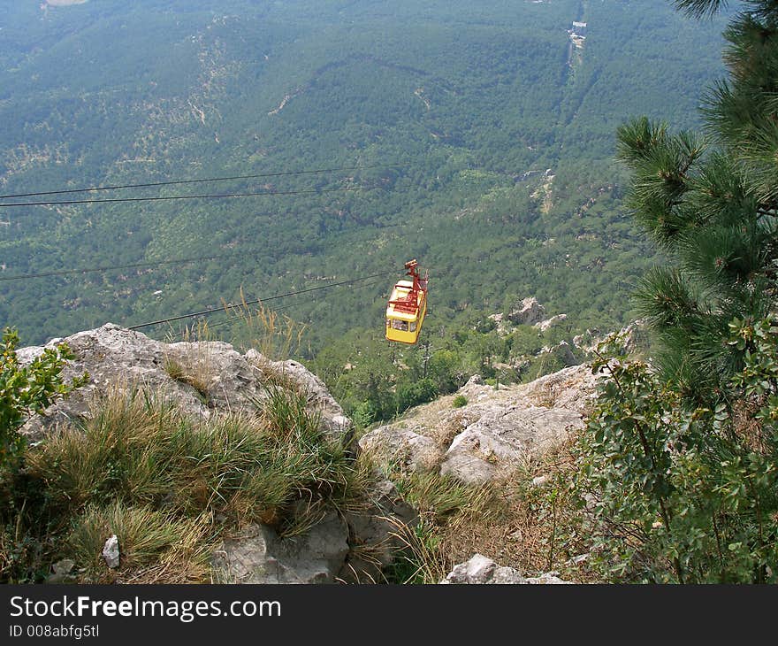 Cable railway on mountains above forest