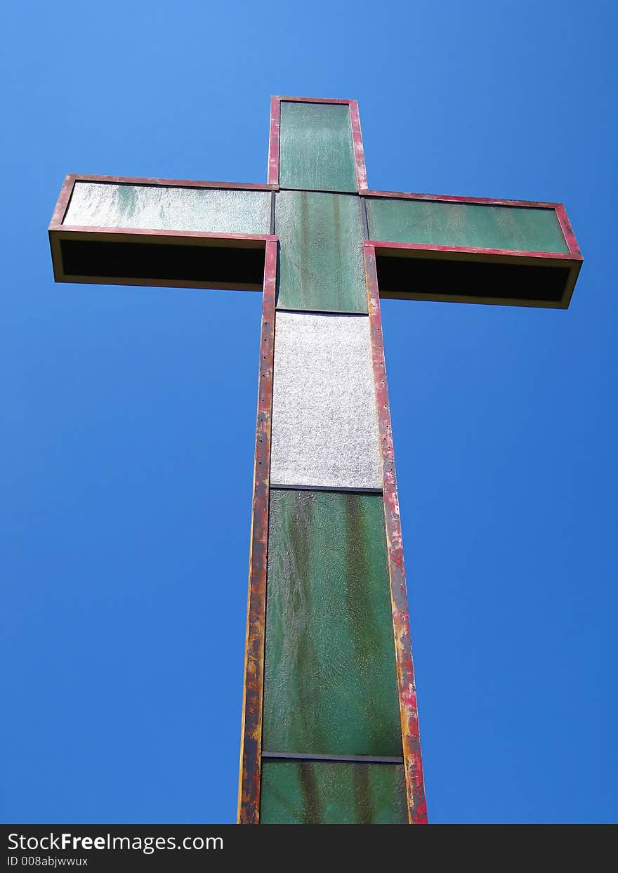 An old cross set against the clear blue sky. An old cross set against the clear blue sky