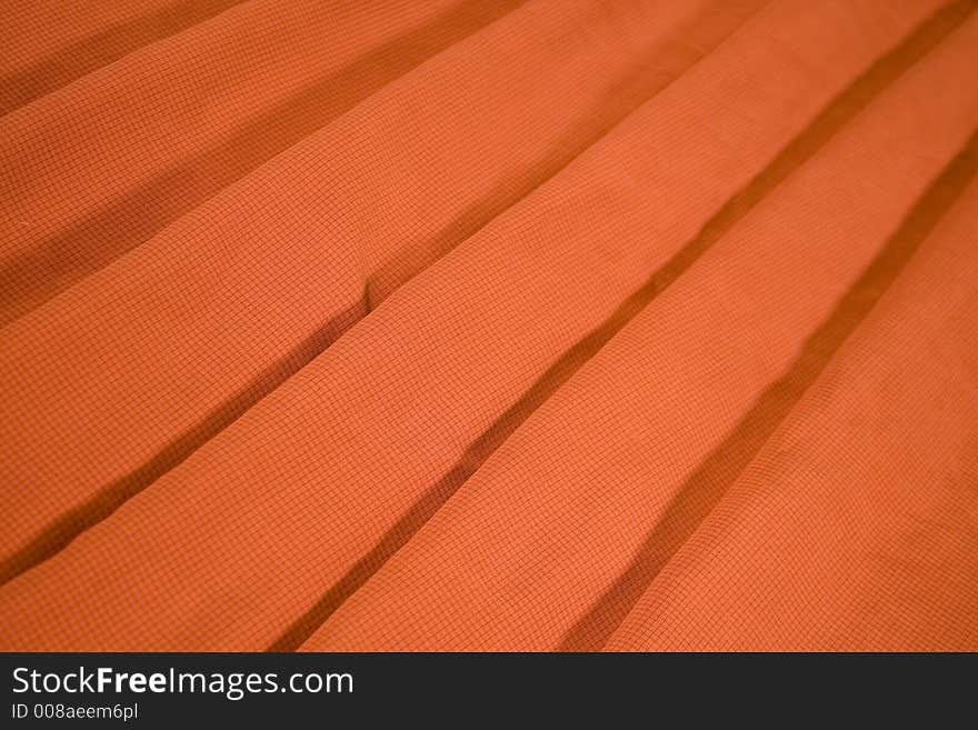 Orange material replicate with fan shape stripes in perspective. Orange material replicate with fan shape stripes in perspective