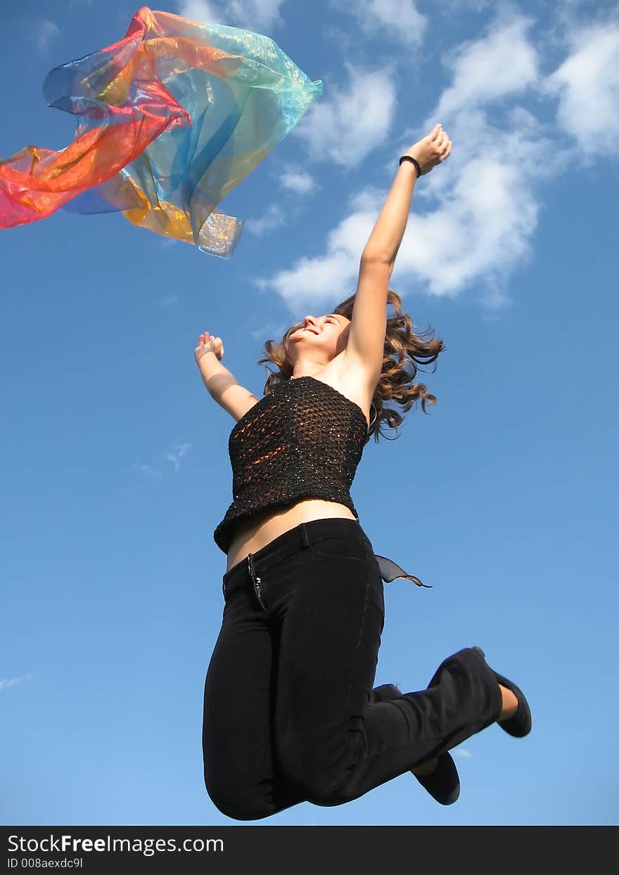 Girl jumping and playing with silk