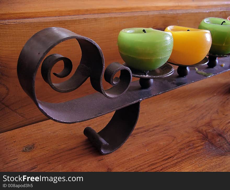 Three wax candles and decorative iron holder. Three wax candles and decorative iron holder.