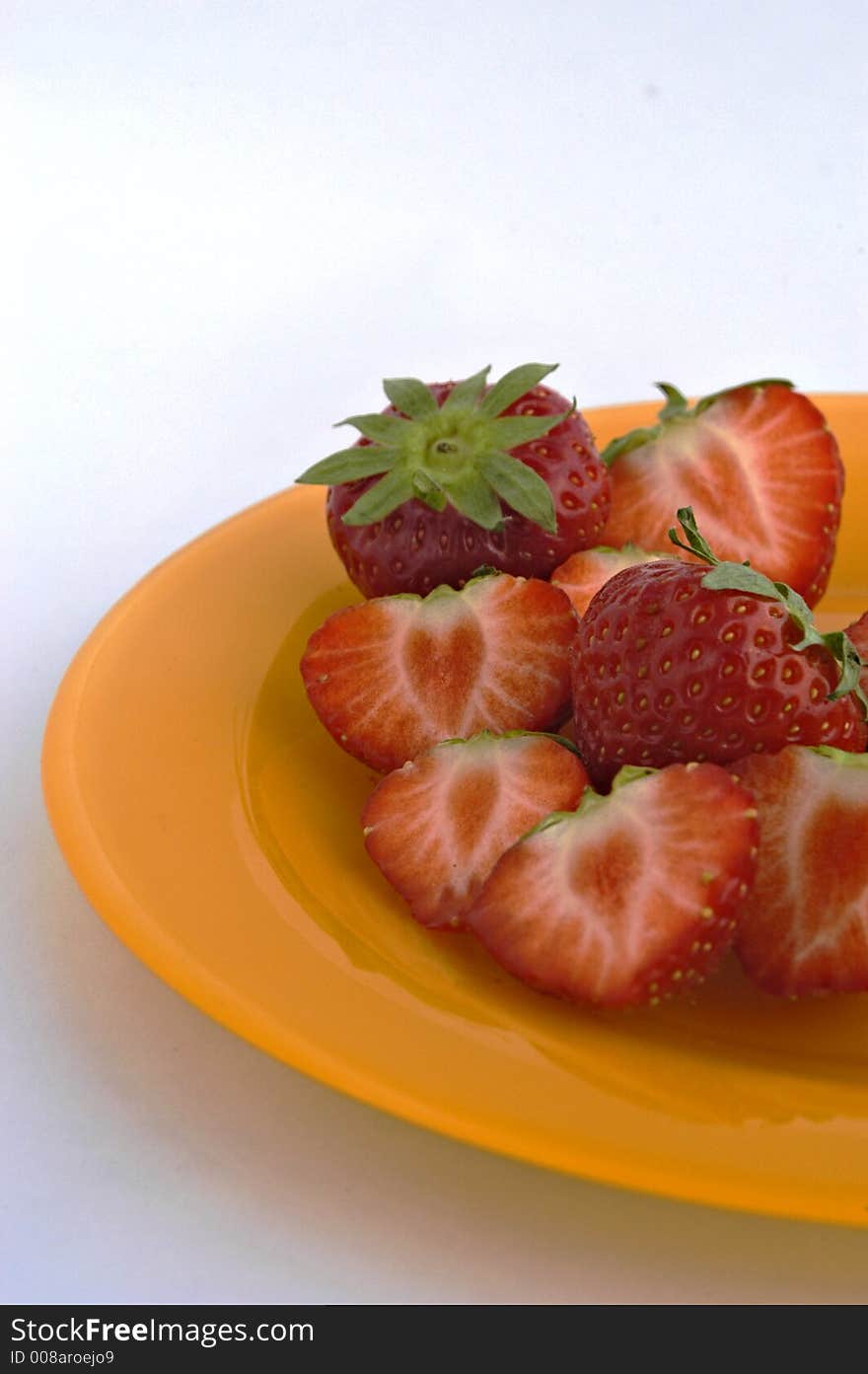 Strawberries on yellow-orange plate. Strawberries on yellow-orange plate.