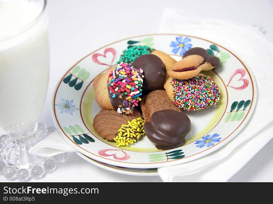 a plate of Italian cookies with milk in a vintage glass