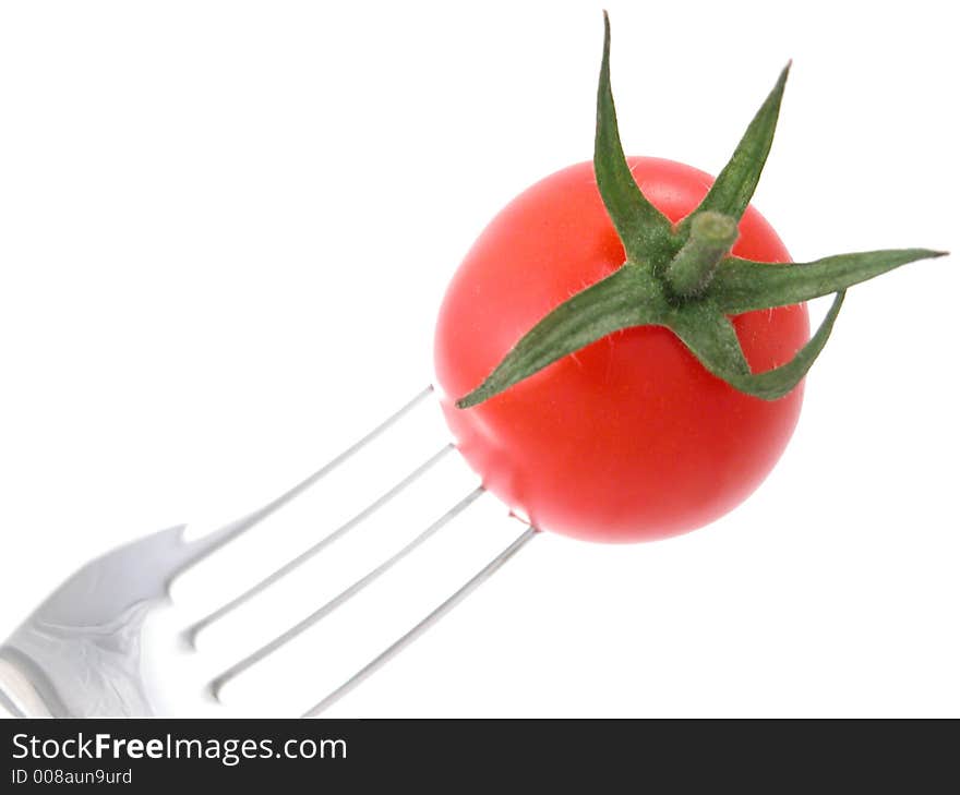 Tomatoes against a white background on a fork