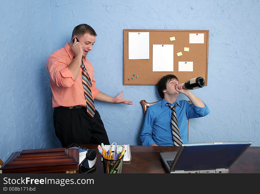 Two male workers drinking and goofing off on the job. Two male workers drinking and goofing off on the job