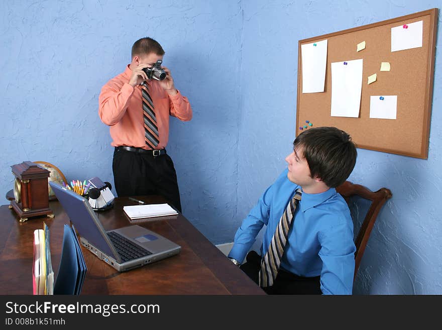 Coworker taking picture of employee