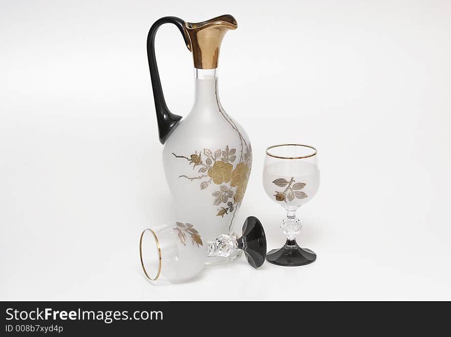 A jug and two glasses on a white background