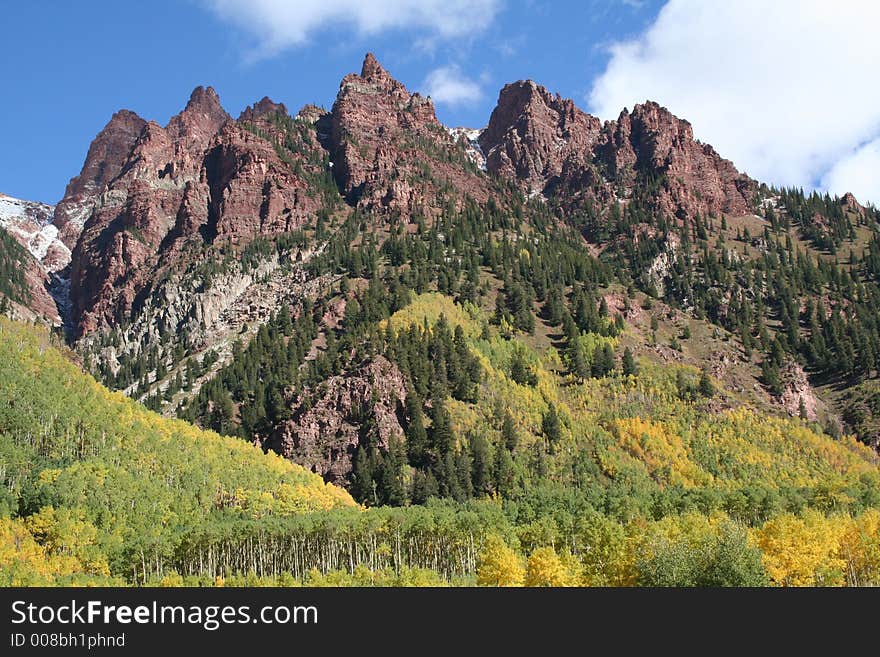 Rugged outcrop against blue sky with clouds. Rugged outcrop against blue sky with clouds