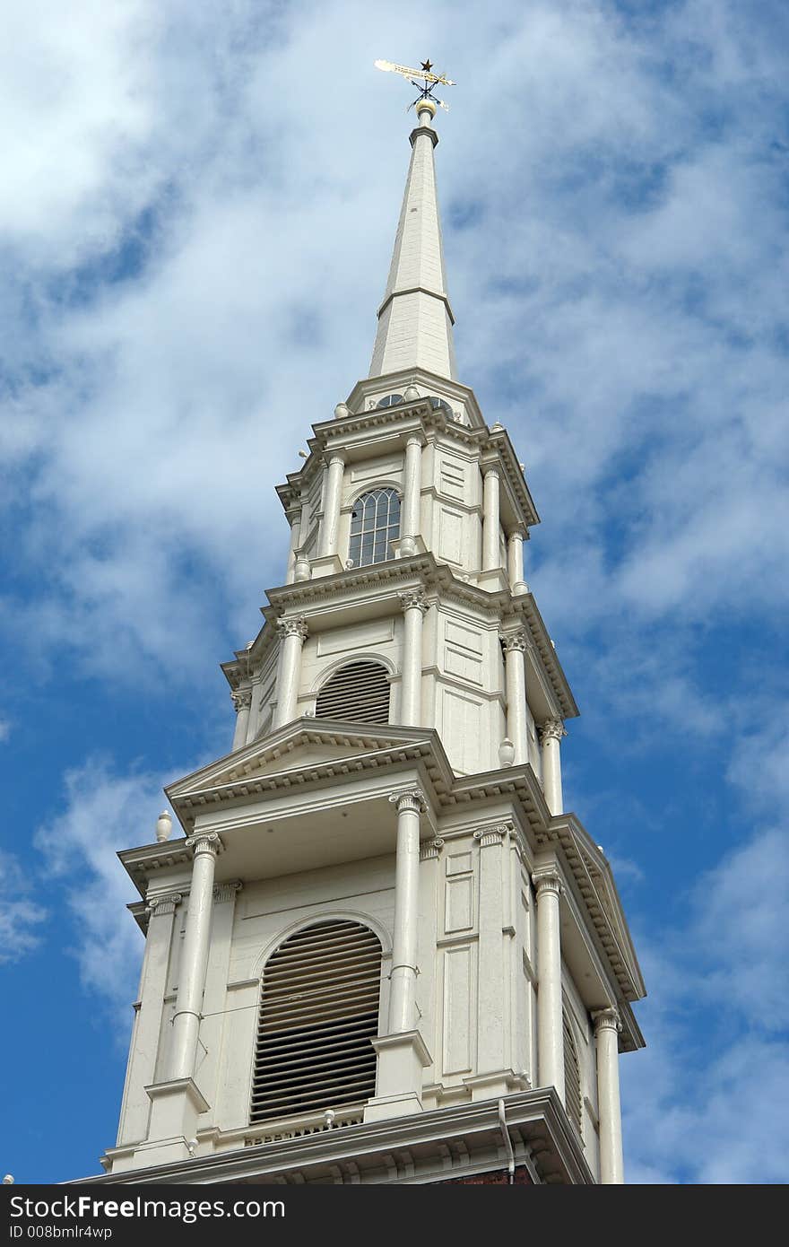 The white steeple of the park street church rises high into the sky above boston. The white steeple of the park street church rises high into the sky above boston