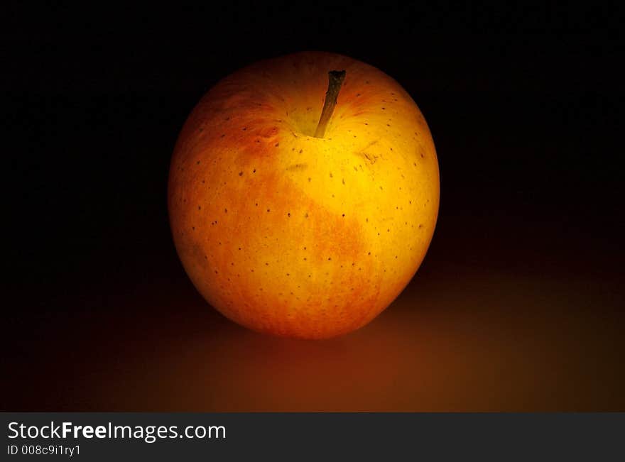 Glowing apple on dark background