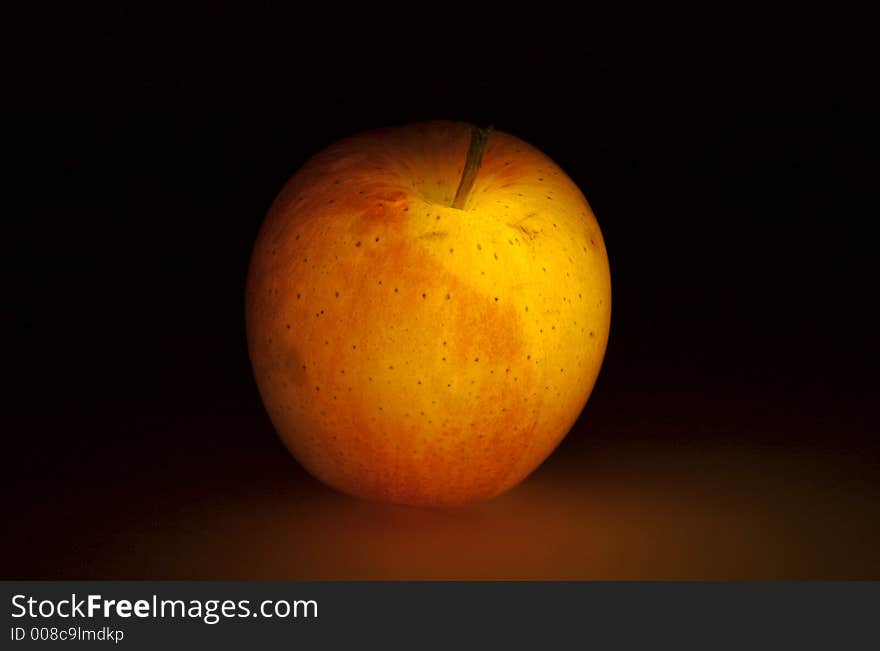 Glowing apple on dark background