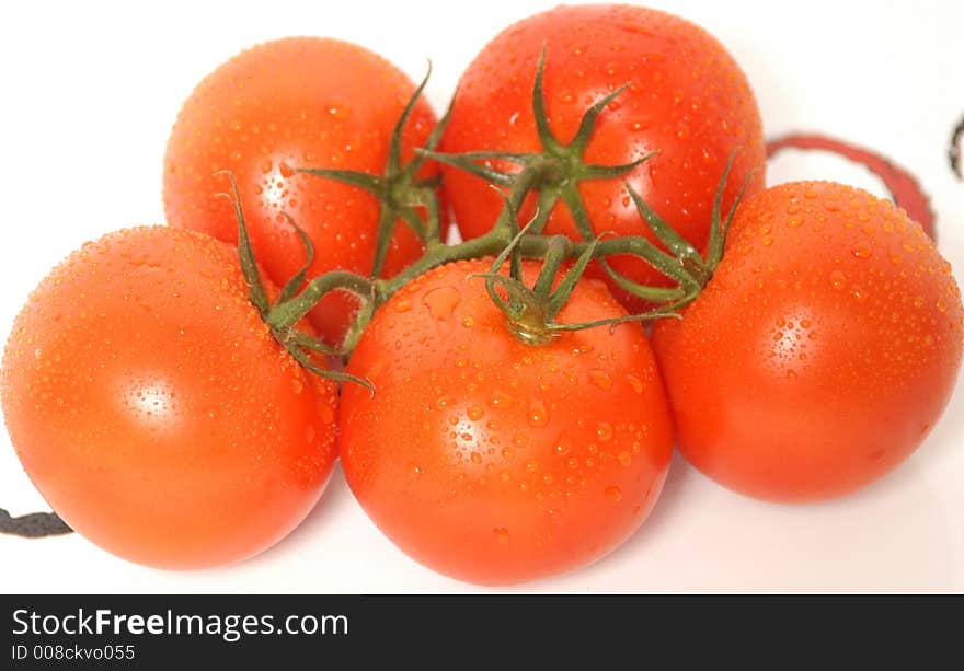 Fresh tomatoes with rain drops in a white dish