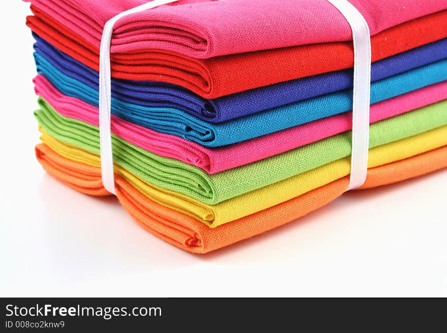 Bundle of coloured material on a white background