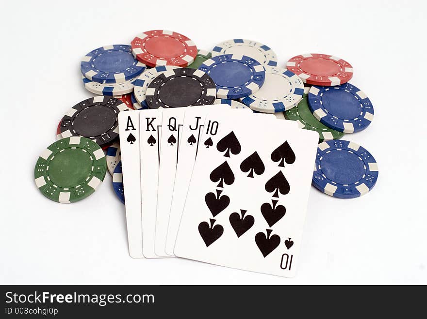 A royal straight flush hand with chips. A royal straight flush hand with chips.