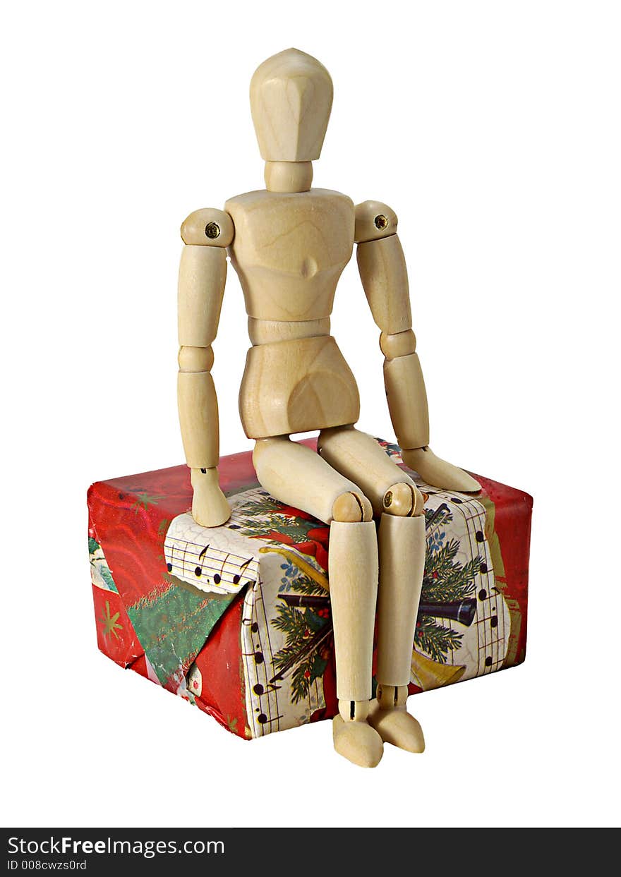 Mannequin sitting on a Christmas gift. Mannequin sitting on a Christmas gift