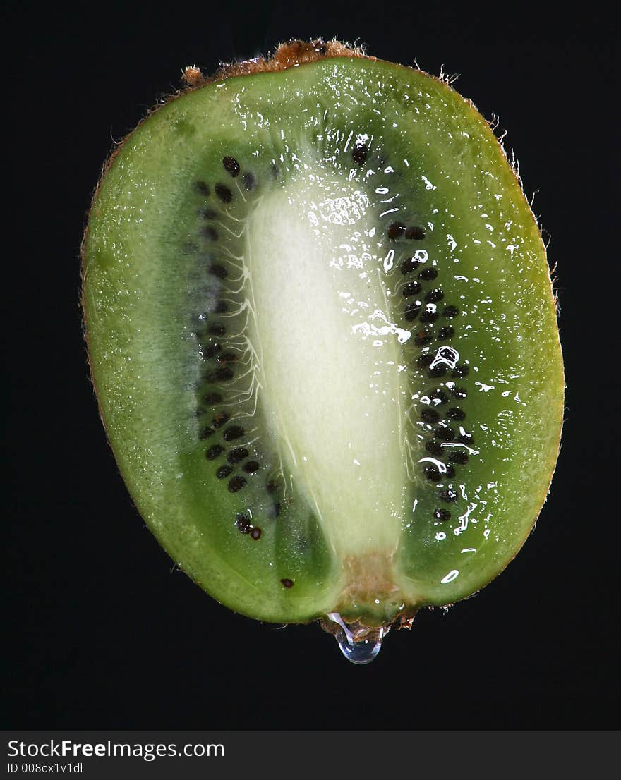 Half kiwi fruit on black background.