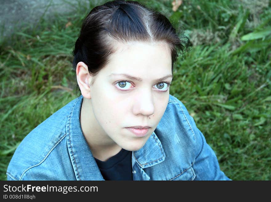 Young woman on the green in the nature