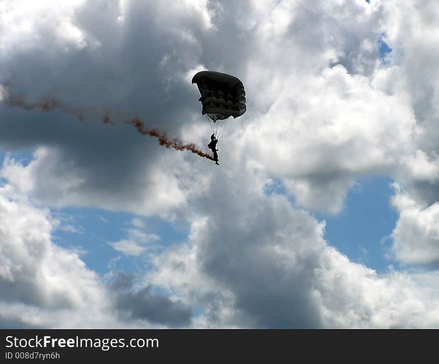 A silhouette of parachute man ready for landing.