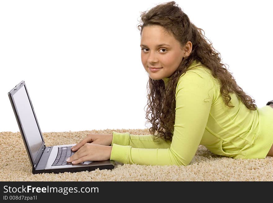 Isolated on white female teenager lying on the carpet with laptop