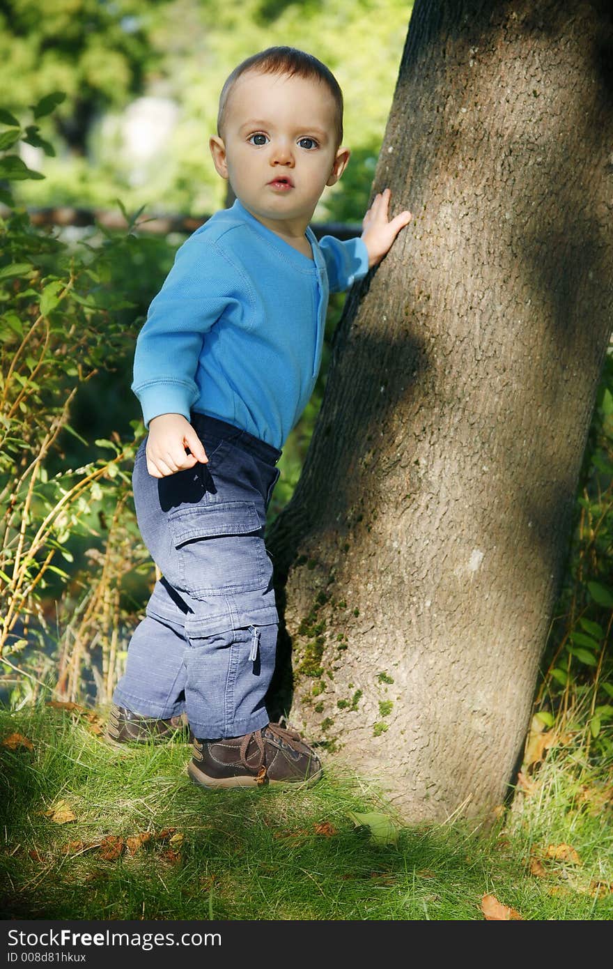 Adorable little boy playing in a park. Adorable little boy playing in a park