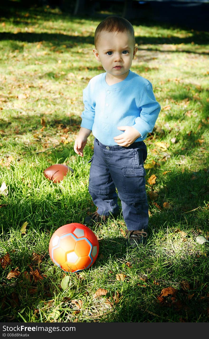 Adorable little boy playing in a park. Adorable little boy playing in a park