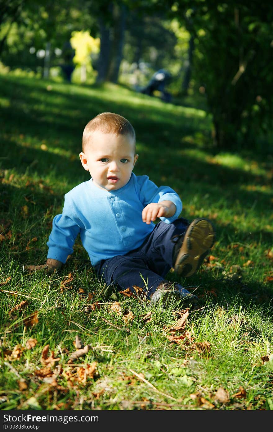 Adorable little boy playing in a park. Adorable little boy playing in a park