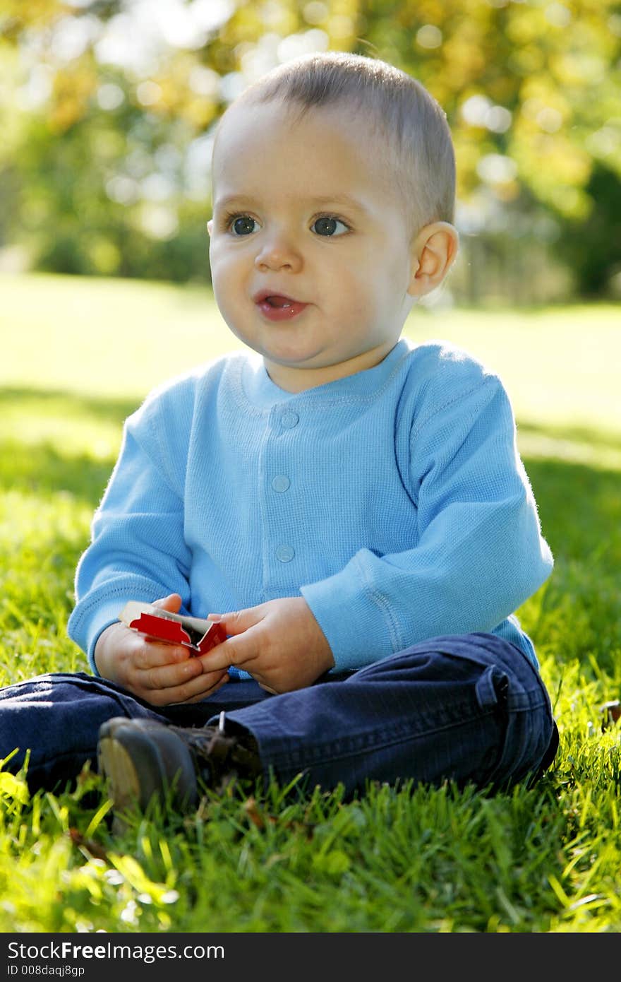 Adorable little boy playing in a park. Adorable little boy playing in a park