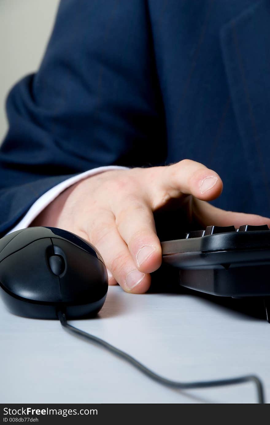 Businessman cruching number on keypad. Businessman cruching number on keypad