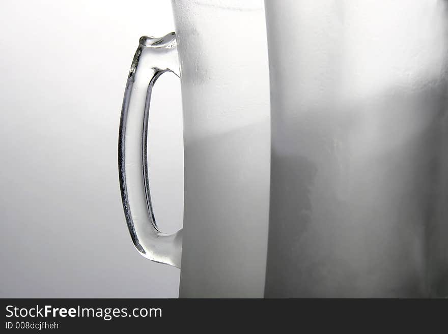 Two frozen beer mugs on a table. Two frozen beer mugs on a table