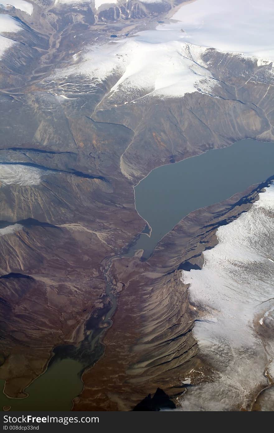 Icy lake in Iceland mountains, aerial view