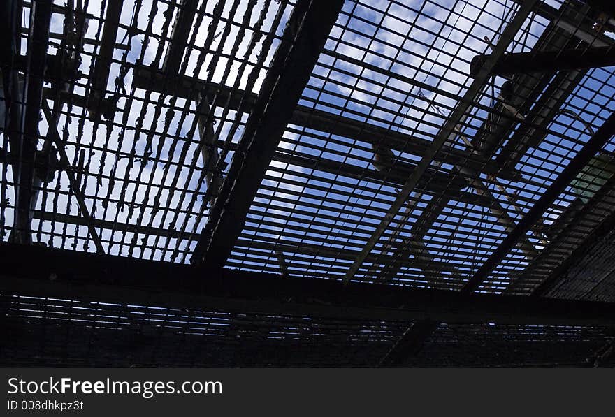 Peeling industrial floor grating against sky. Peeling industrial floor grating against sky