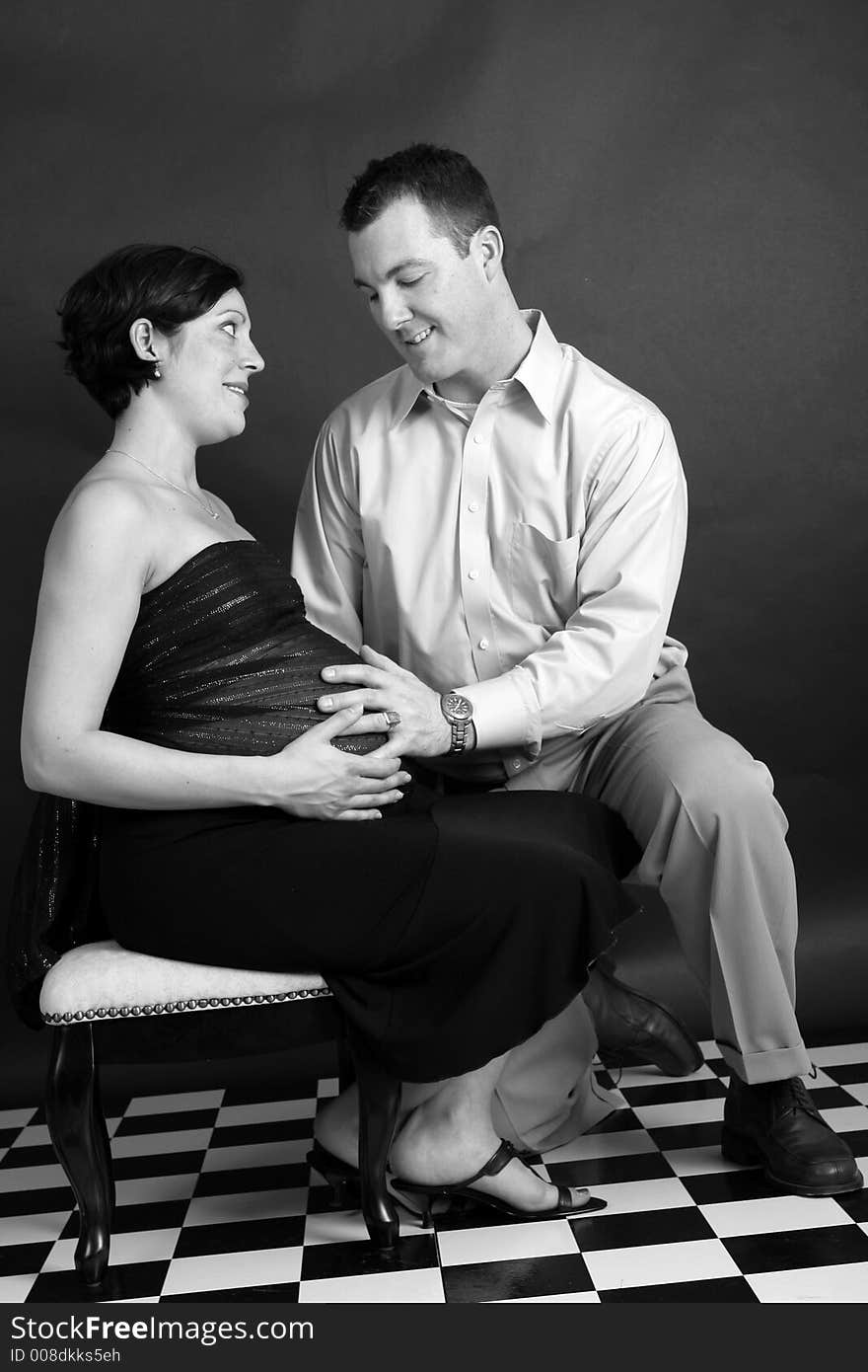 Black and white portrait of a pregnant woman and her husband. Black and white portrait of a pregnant woman and her husband.