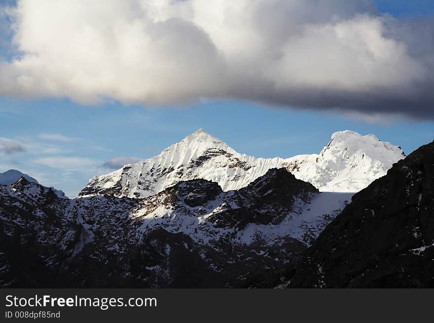 Snowcowered peaks and storm clouds in the Cordillera mountain. Snowcowered peaks and storm clouds in the Cordillera mountain