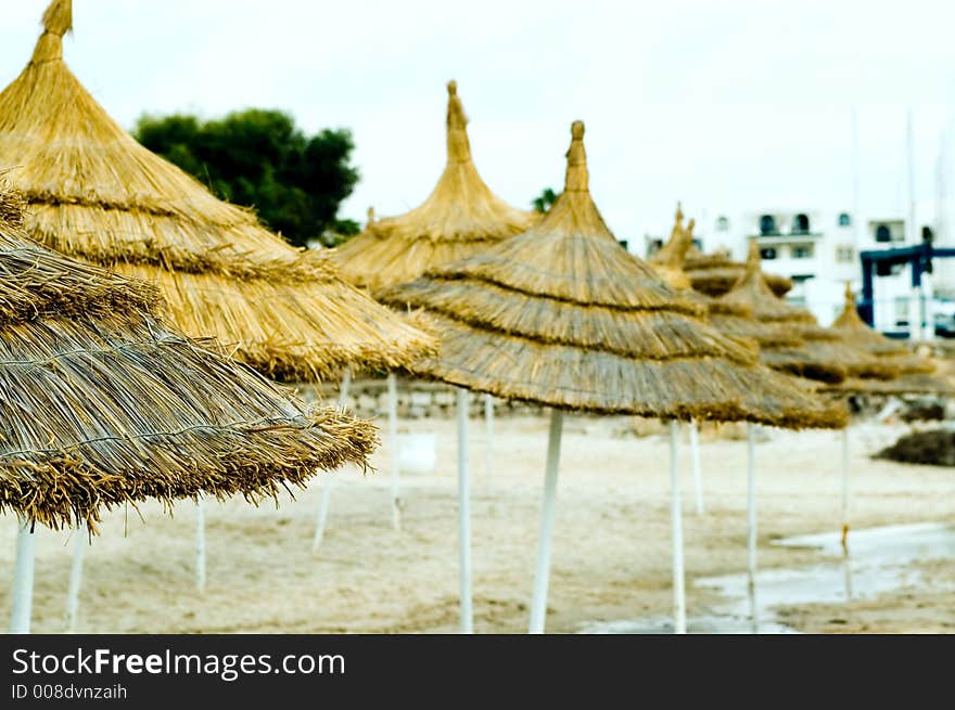 Few sun umbrellas on a hotel beach - shallow depth of field