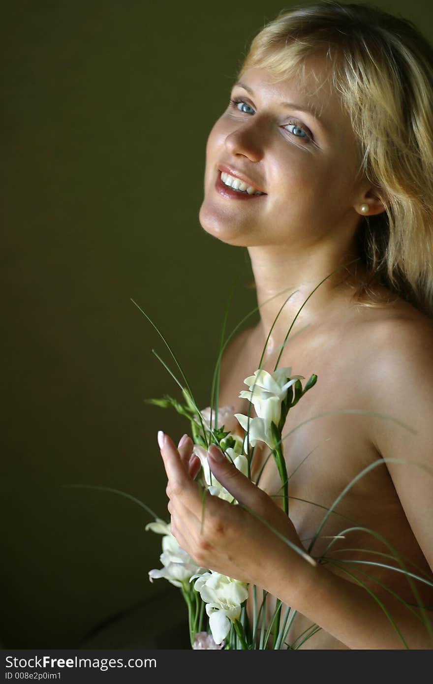 Portrait of the beautiful blonde with a bouquet of flowers