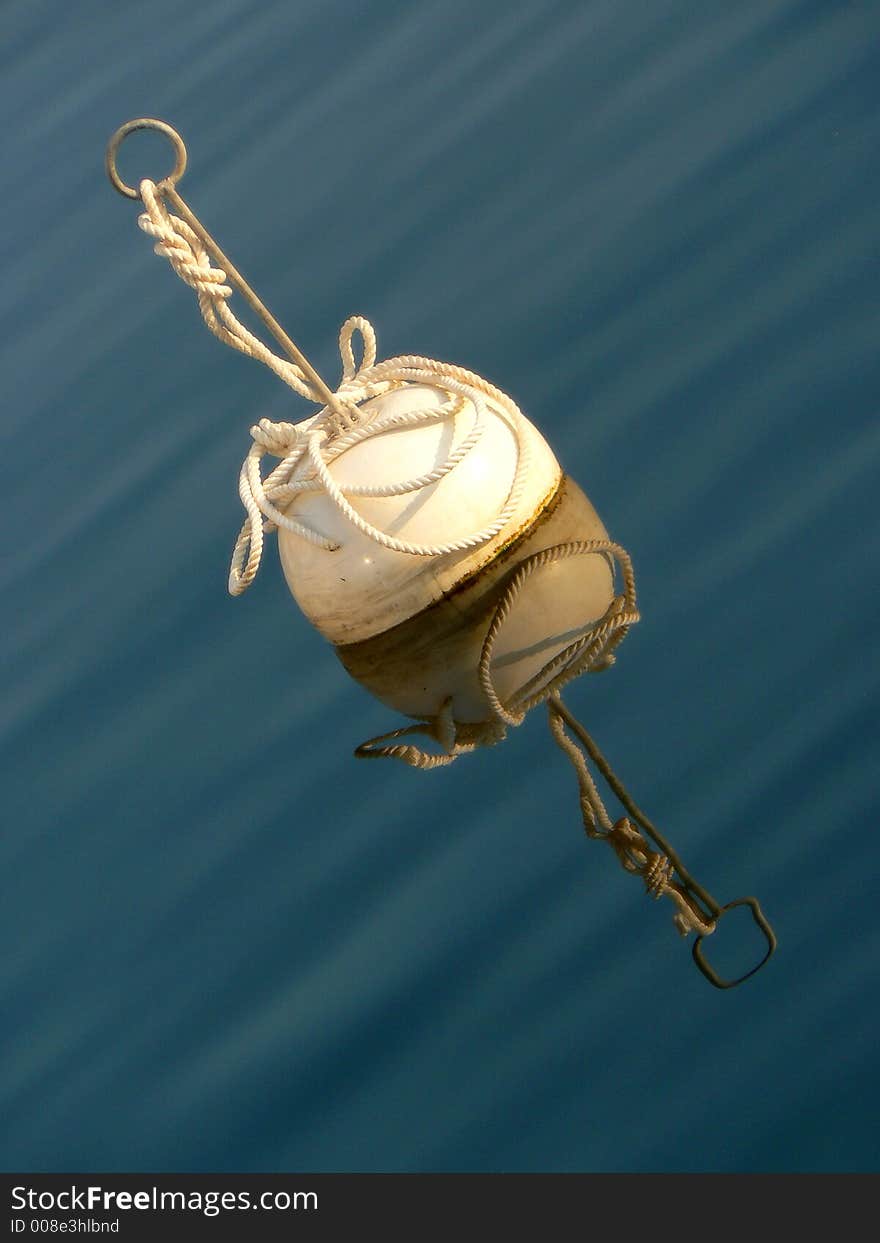 WHITE BUOY REFLECTING IN CALM WATER