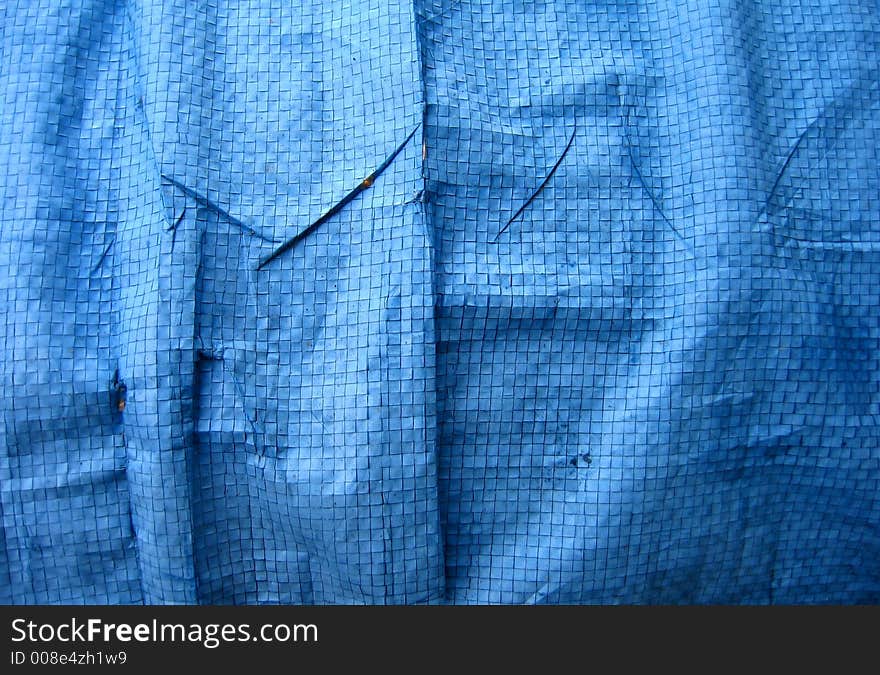 Wrinkled blue tarpaulin makes a complex background