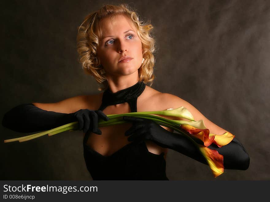 Portrait of the girl in a black dress with callas. Portrait of the girl in a black dress with callas