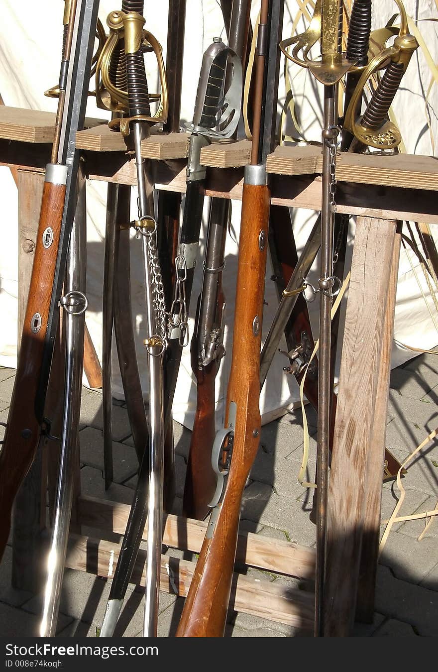 Rack of vintage weaponry at reenactment-show