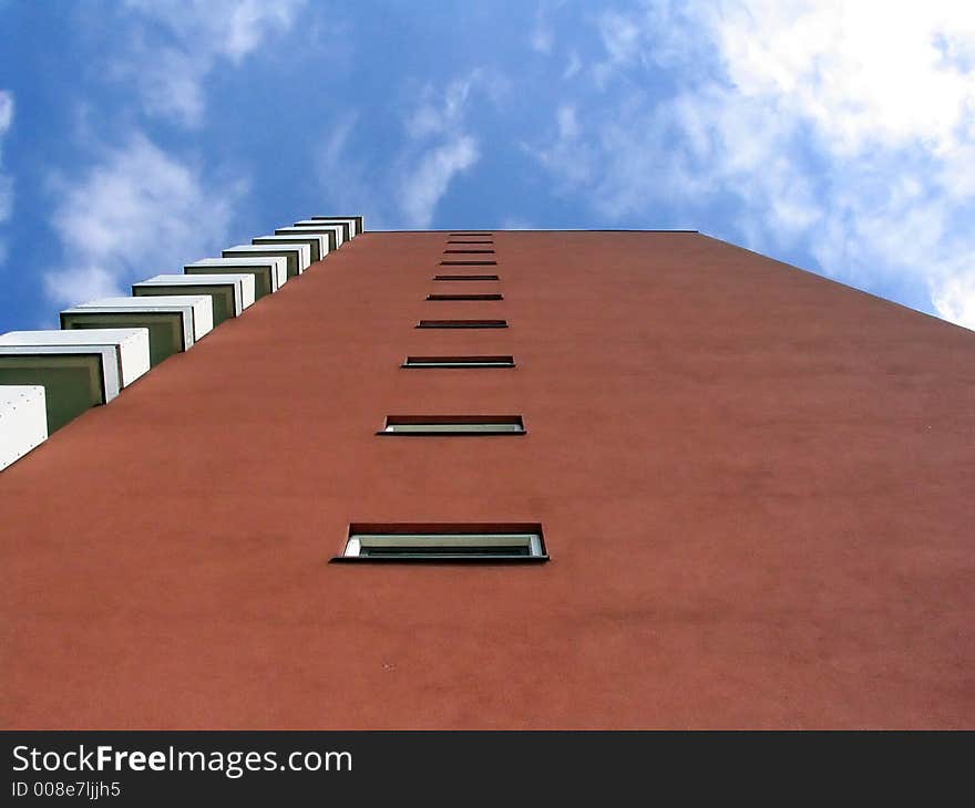 A modern red building on a warm summer day. A modern red building on a warm summer day.