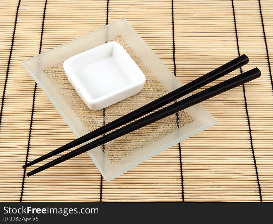 Sushi plate and chopsticks on bamboo mat. Sushi plate and chopsticks on bamboo mat