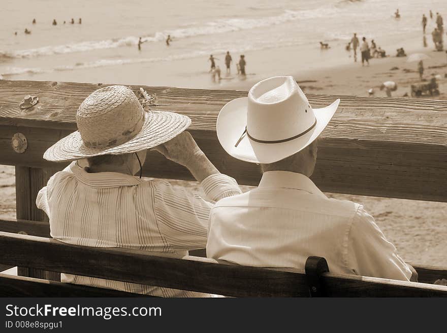 Old-fashioned treatment of a married couple enjoying a view of Californian beach. Old-fashioned treatment of a married couple enjoying a view of Californian beach