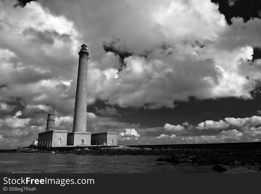 A lighthouse in Normandy France with large cloudscape. A lighthouse in Normandy France with large cloudscape