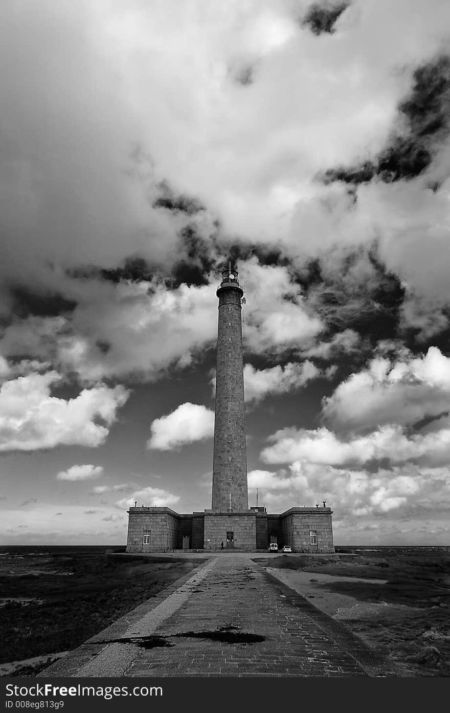 A lighthouse in Normandy France with large cloudscape. A lighthouse in Normandy France with large cloudscape