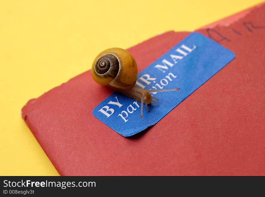 A snail crawls over a par avion (air mail) stamp on a letter to represent snail mail. A snail crawls over a par avion (air mail) stamp on a letter to represent snail mail.