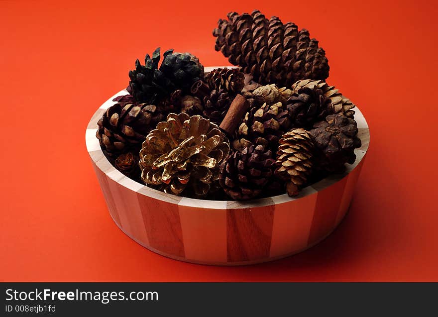 An arrangement of scented pinecones on a red background. An arrangement of scented pinecones on a red background